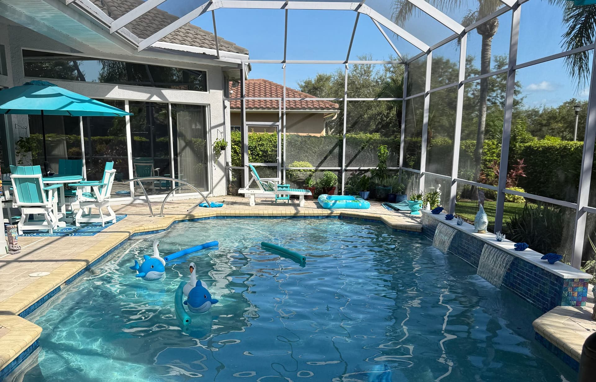 Custom freeform residential pool with raised spa after weekly maintenance service by Bayview Pool Pros