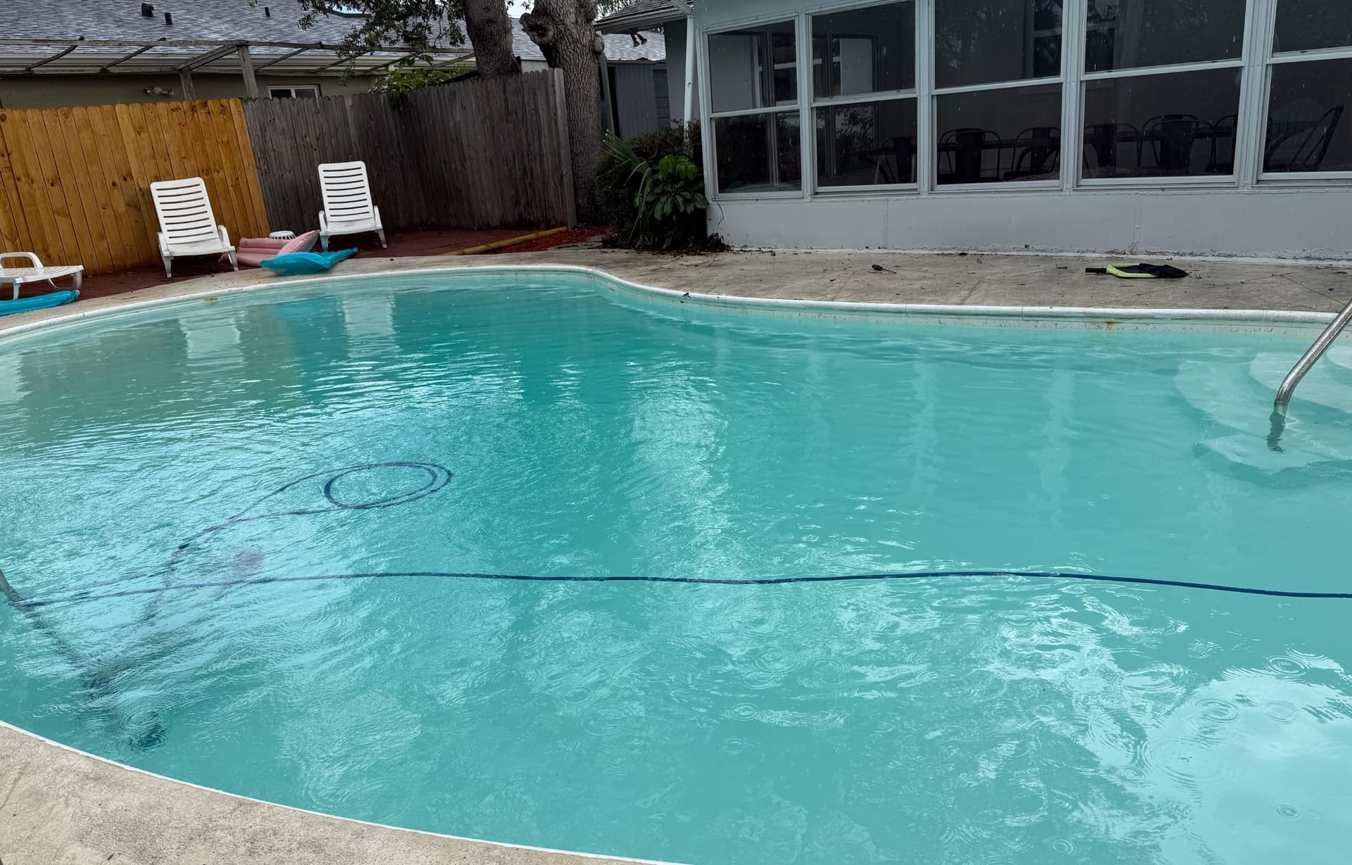 Rectangular pool with crystal clear water during maintenance service